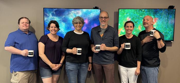 The ExoFOP team showing off their new ExoFOP mugs.