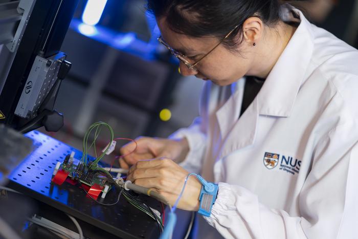 ST-NUS HELIX Lab - Researcher testing a silicon chip research prototype