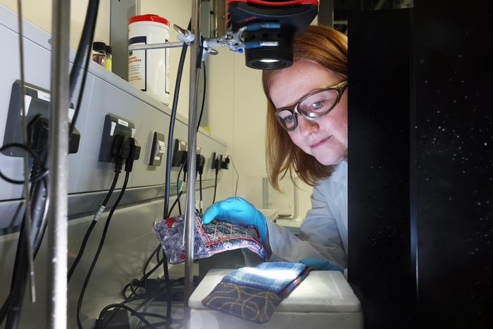 Dr Jennifer Edwards checking light properties of SunPad