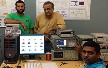 Three Scientist with Computers and Equipment in a Lab