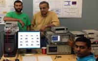 Three Scientist with Computers and Equipment in a Lab