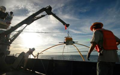 Marine Scientists on a Ship at Sea Hauling in an Electomagnetic Reciever