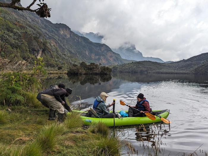 Students return from collecting a core sample in a lake in Uganda's Rwenzori Mountains.
