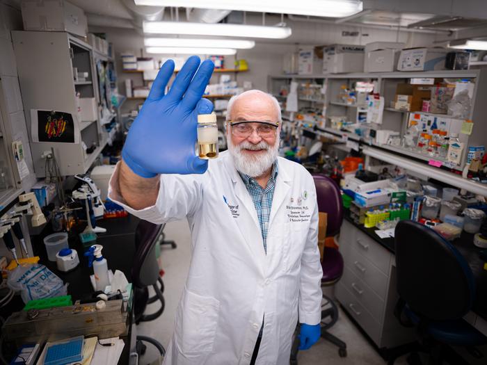 Brian Stevenson, Ph.D., displays a preserved tick specimen in his laboratory. Photo by Jeremy Blackburn, UK Research Communications.