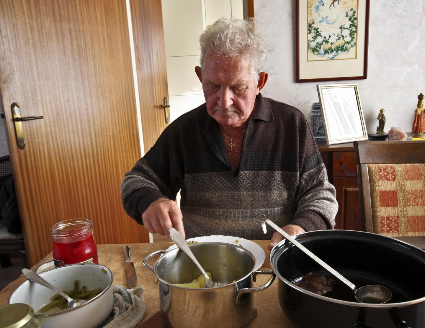 Elderly man eating