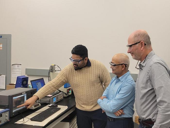 researchers discussing ceramic materials