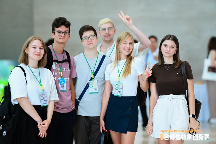 Members of competing teams at SynBio Challenges pose for a photo in Shenzhen, south China's Guangdong Province, August 7, 2025.