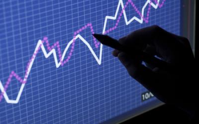 Photo Showing a Hand Pointing at a Graphic on a Screen