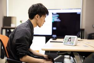 Higashinaka Lab PhD students testing AI dialogue systems