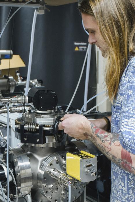 Study author Nathan McLane operates the vacuum-sealed chamber used in this study.