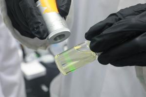 Near-infrared laser shined on nanoparticles suspended in a liquid
