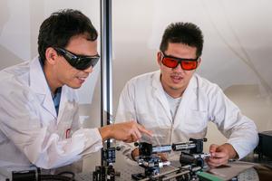 (left) Nanyang Asst Prof Shen Yijie with his researcher discussing the experiment for optical skyrmions