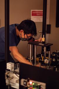 Researcher building microscope