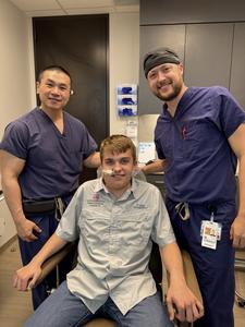 From left, James Melville, DDS, Geordon Boulware, Christopher Middling, DDS, MD, posing after tumor resection. (Photo by Mamie Boulware)