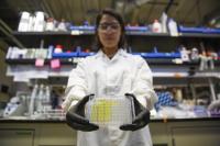 Tara deBoer holds DETECT Well-Plate