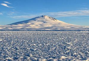 Sea ice off Victoria Land, Antarctica, with Mount Melbourne in the background.