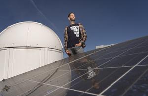 Alex Tro on the roof with photovoltaic panels