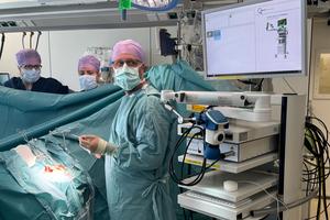 A medical team uses the imaging device during a non-brain cancer surgery.
