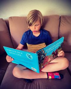Micah's brother reading Forever Our Little One