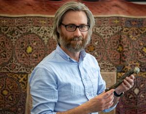 Dr. Alan Turner (Stony Brook University) holding the femur of Labrujasuchus expectatus