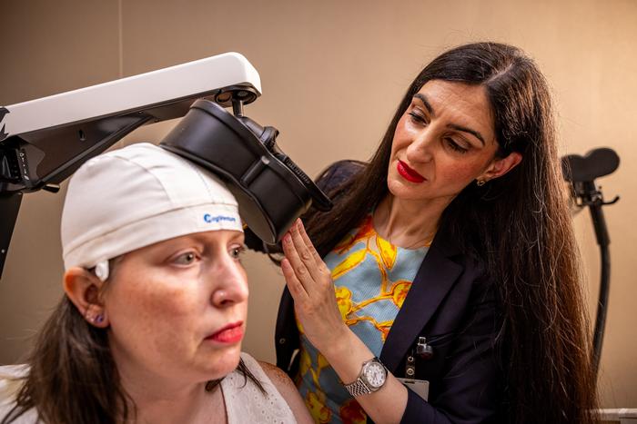 Rana Jawish adjusts TMS machine