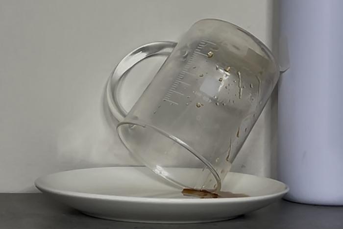 Syrup being tipped out of a beaker for measurement