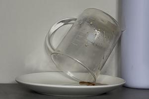 Syrup being tipped out of a beaker for measurement