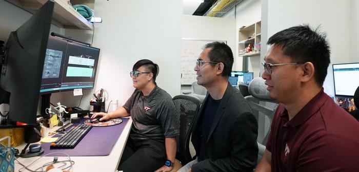 (from left) Postdoctoral researcher Jiali Li, Assistant Professor Zhenhua Tian, and postdoctoral researcher Luyu Bo analyze acoustic waveforms in Tian's lab.