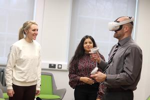 Meg Bowyer, Simran Cheema and David Webb demonstrating the app