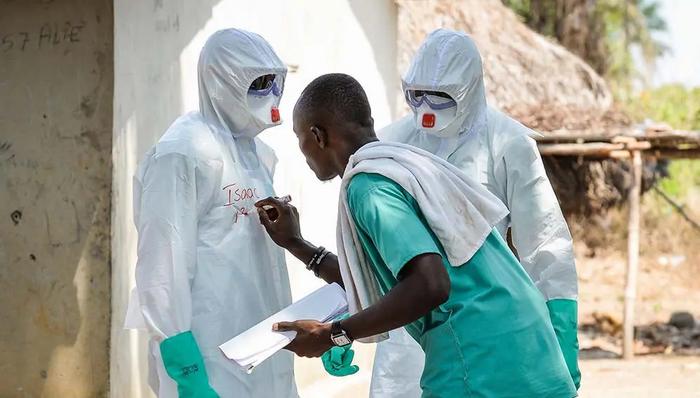 Members of a decontamination team wearing safety suits during the West Africa Ebola epidemic in 2015.
