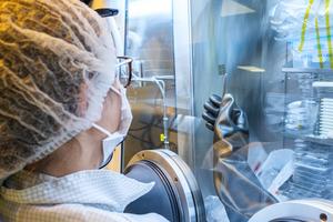NTU research fellow Dr Daniela De Luca examining a prototype ultrathin perovskite solar cell in the vacuum chamber in the lab.