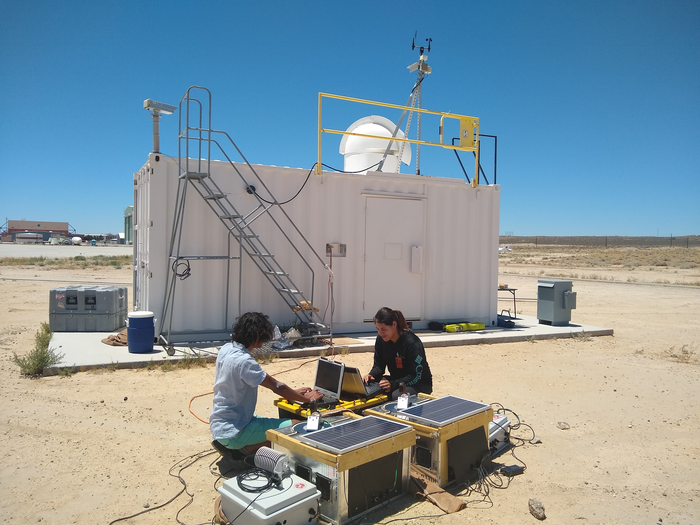Researchers analyzing wildfire emissions from a distance
