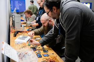 Cybersecurity specialists must figure out the significance of multiple objects and clues in an escape room exercise as part of ICS Cybersecurity Lab Training.