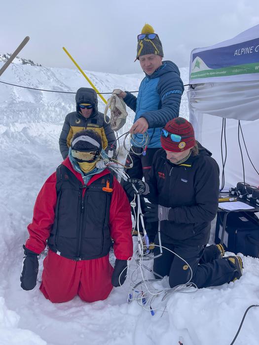Participant ready for burial. Giacomo Strapazzon (kneeling) and Frederik Eisendle (blue jacket) both are researchers and doctors who led the study.