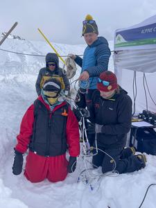 Participant ready for burial. Giacomo Strapazzon (kneeling) and Frederik Eisendle (blue jacket) both are researchers and doctors who led the study.