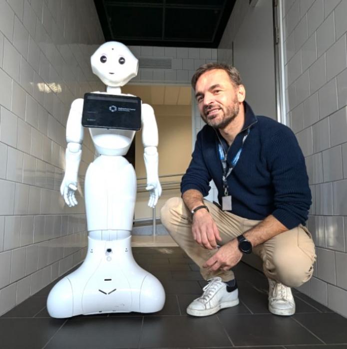Konrad Maj (Ph.D.), social psychologist, SWPS University and robot Pepper