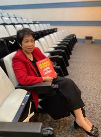 Hwee Hua Lim holding a copy of 