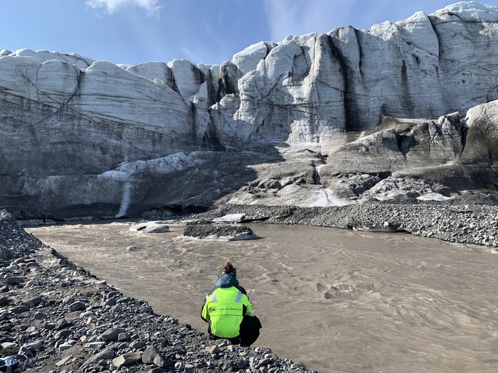 Taking water samples from a glacial river on Svalbard
