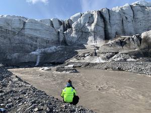 Taking water samples from a glacial river on Svalbard