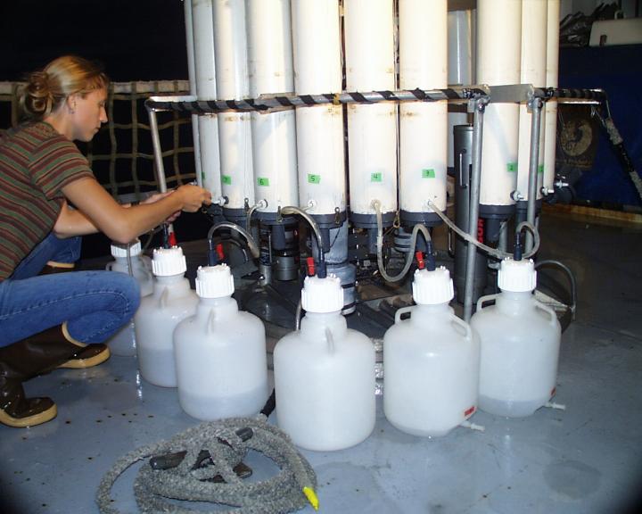 Crew Member Collects Water Samples