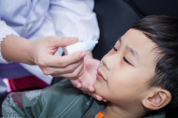Kid getting Eye Drops