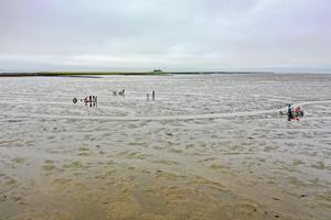 Examining the remains of the former church of Rungholt in the tidal flats off Hallig Südfall