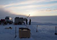 Team drilling through ice