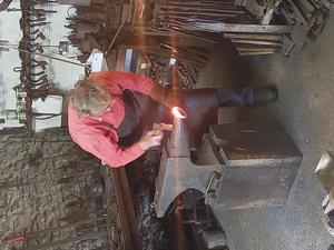 Forging a ring-handle for the replica cauldron.