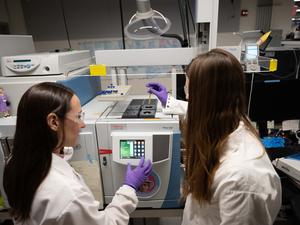 Two researchers studying space dust