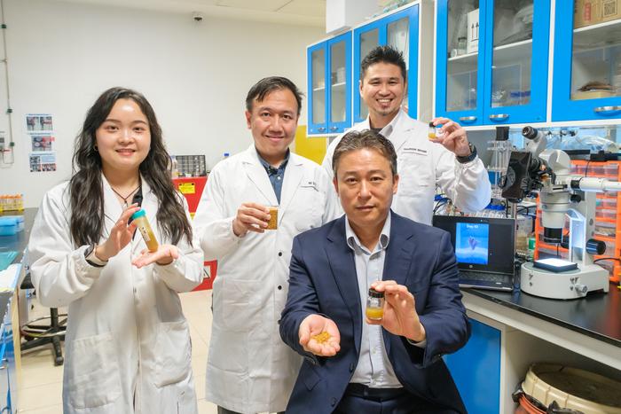 NTU Singapore Prof Cho holding the pollen-based sunscreen in a bottle