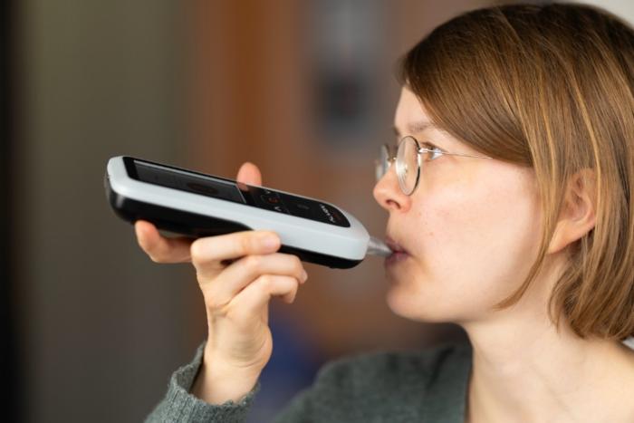 Participant using the breath acetone analyzer