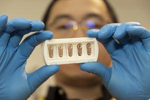 Dr Zihao Wang holding the assembled 3D printed blood vessel device.