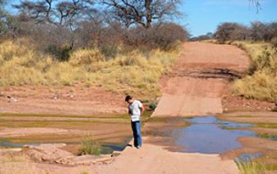 Kyle Nichols Standing Next to Wet River Crossing