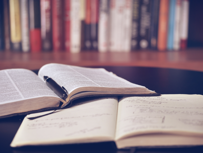 An open book and notebook.